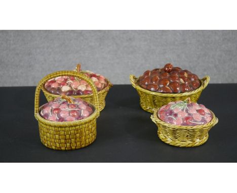 A collection of four early 20th century French Sarreguemines majolica ceramic fruit design lidded tureens, woven effect to ba