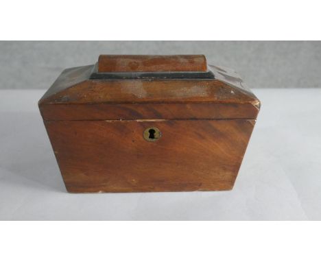 A George III mahogany sarcophagus form tea caddy, with ebonised detail, two wells to the interior. H.14 W.21cm 