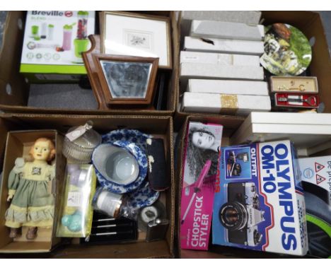 A mixed lot to include commemorative plates, an Olympus OM - 10 camera, car anti-skid  covers, a selection of candles, a Brev