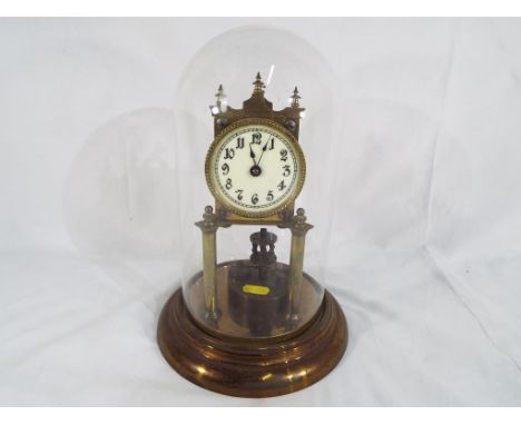 A 400-day Anniversary clock, mechanical movement by Jahresuhrenfabrik mounted on pillars and surmounted by a top pediment wit