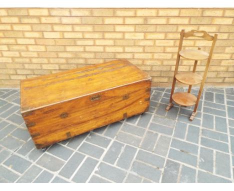 A good quality wooden chest on castors 105 cm x  52 cm x  37 cm and a good quality 3 tier wooden cake stand approx 81 cm high