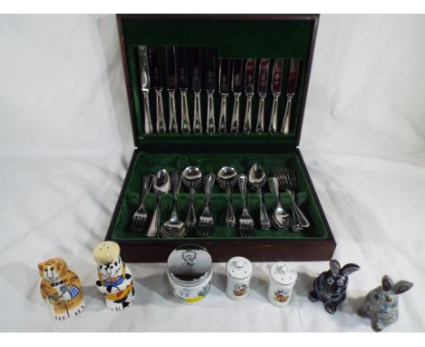 A good quality canteen of cutlery, a Royal Worcester egg coddler,a salt and pepper shaker in the form of cats, a Disney salt 