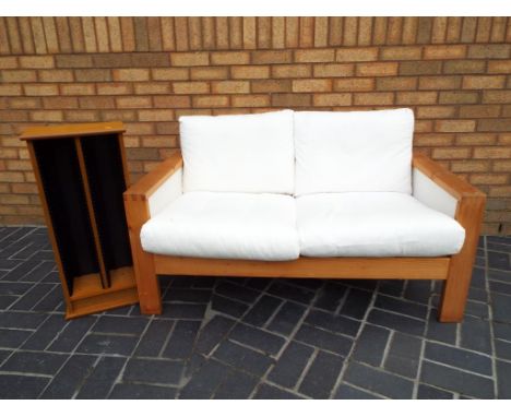 A good quality modern pine framed Ikea 2 seater sofa 74 cm x 130 cm x 84 cm and a pine CD rack 75 cm x 43 cm x 19 cm (2)