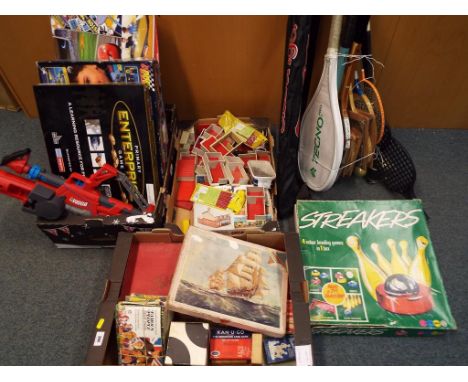 A good mixed lot to include Streakers 4 in 1 games box, a quantity of tennis racquets and hockey sticks, vintage playing card