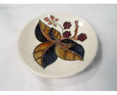 Moorcroft Pottery - a pin dish decorated with blackberries, 12 cm (diameter) - Est £30 - £50