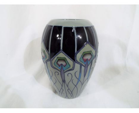 Moorcroft - a Moorcroft vase decorated in the Peacock Parade pattern, approximate height 19 cm (h). Estimate £80 - £120