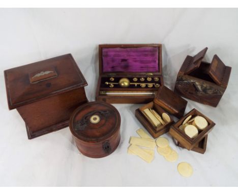 A large quantity of wooden boxes to include an oak tea caddy and a walnut cigarette box, ivory gaming counters, a hydrometer 