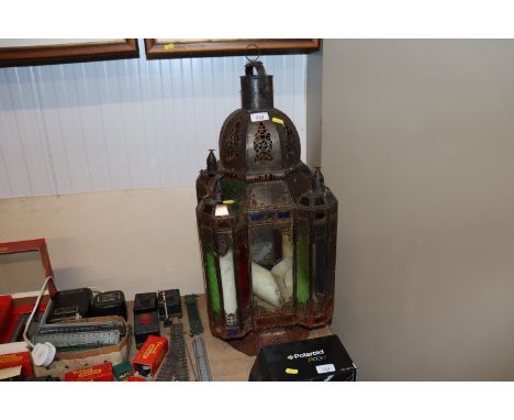 An Eastern metalware and coloured glass hanging lamp