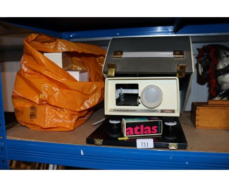 A Braun Triumph projector and a quantity of slid reels etc