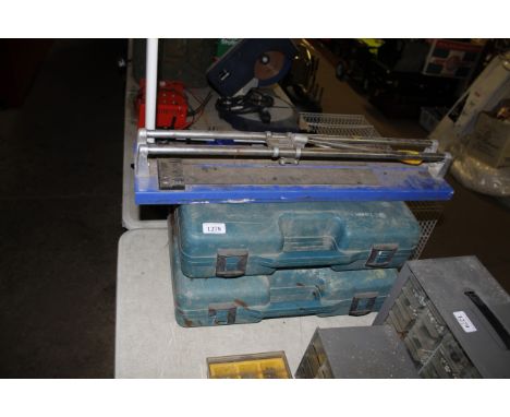 Two Makita tool boxes and a tile cutter