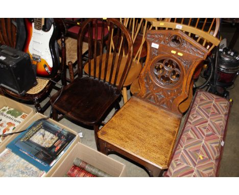 A Victorian carved oak Gothic design hall chair together with a stick back kitchen chair