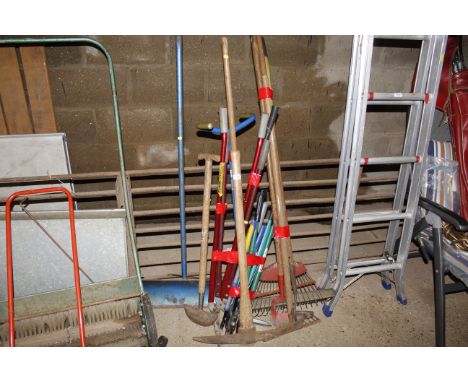 A collection of long handled garden tools to include garden edgers, garden rake, pick axe etc. 