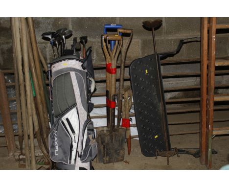 A bundle of garden tools including forks and spades