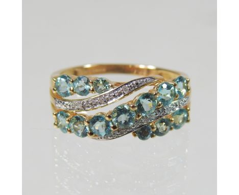A 9 carat gold green tourmaline and diamond ring, of crossover design, size R, 3.6g gross, boxed