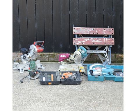 A Makita mitre saw, together with a Makita grinder, other tools and a work bench