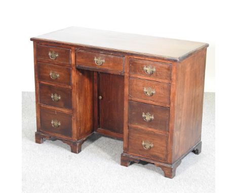 An early 20th century mahogany kneehole desk, on bracket feet, 107cm