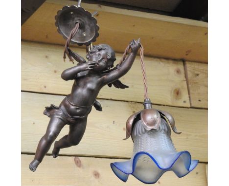 A late 19th century bronzed hanging ceiling light, in the form of a cherub, with a glass shade, together with a white alabast