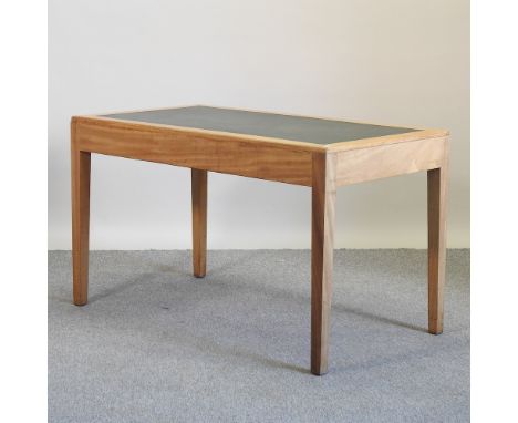 A mid 20th century light oak writing table, 129cm