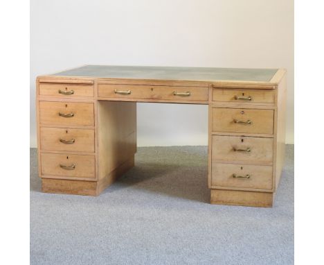 A mid 20th century light oak pedestal desk, 151cm