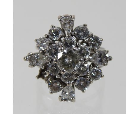 An unmarked diamond cluster ring, the central stone approximately 0.75 carats, surrounded by two rows smaller, of mixed cut d