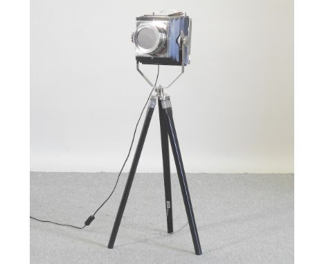A modern chrome stagelight, on a tripod base, 112cm high