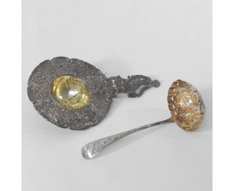 An Edwardian silver sugar sifting spoon, Birmingham 1902, together with a continental silver tea strainer, import marks Chest