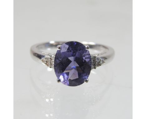 A 9 carat gold, tanzanite and diamond ring, size R, 4g gross, boxed