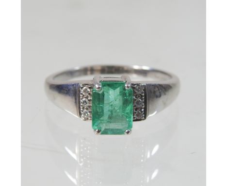 A 9 carat gold emerald and diamond ring, size R, 3.7g gross, boxed