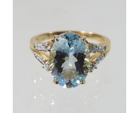 An unmarked topaz and diamond ring, with open diamond set shoulders, size R, 4.6g gross, boxed