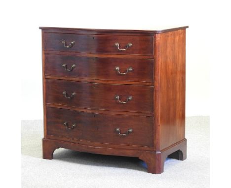 An Edwardian mahogany serpentine chest, containing four long drawers, on bracket feet, 90cm