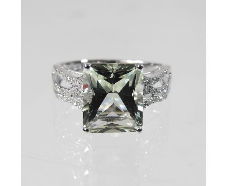 A 9 carat gold topaz and diamond ring, with diamond set shoulders, size R, 4.5g, boxed