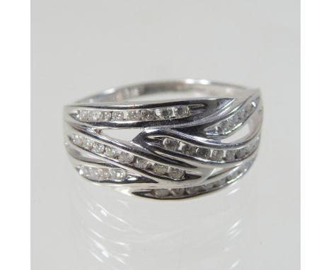 A 9 carat white gold and diamond set dress ring, of multi crossover design, size R, 3.6g gross, boxed