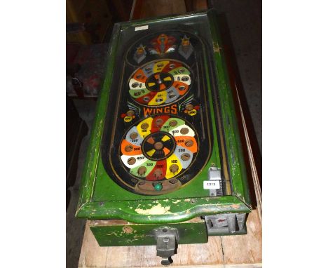 WINGS; an early 20th century green painted pinball machine, length 84cm (in need of restoration).Condition Report: Appears to