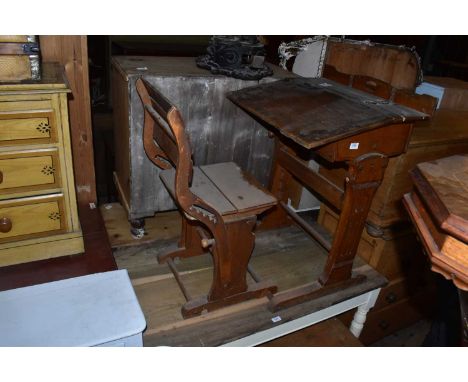 A vintage pine child's desk with adjustable chair.