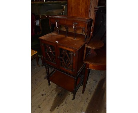 An early 20th century mahogany cabinet with raised back, with short drawers above mirrored panel and two glazed doors, with u