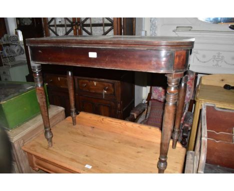 A Georgian mahogany fold-over tea table on turned column legs, height 73cm, width 90cm, depth 46cm.