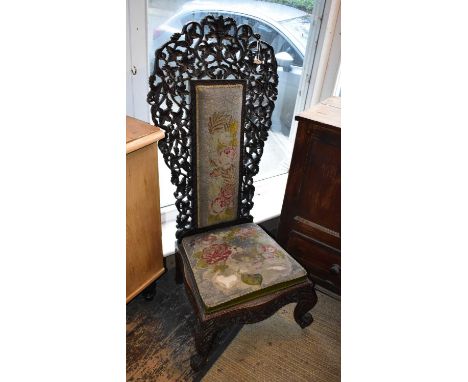 A 19th century carved prayer chair with tapestry back and seat on scrolling supports.Condition Report: The back is loose, spl