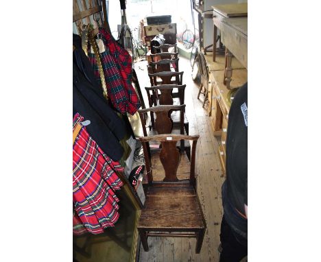 A harlequin set of seven 18th century kitchen chairs with vase shaped splat backs and panelled seats (7).Condition Report: Ag