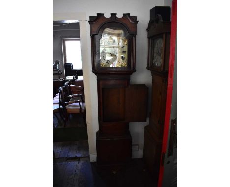 An 18th century oak cased longcase clock, the painted dial set with troops within a landscape setting, above a face painted w