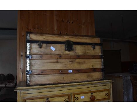 A metal bound pine dome top travelling trunk, width 84cm.