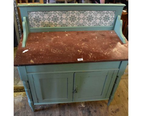 A painted pine wash stand, the raised back set with five ceramic tiles, above a marble top, single drawer and two panelled do