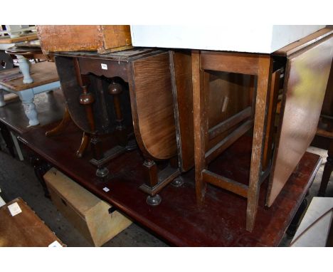 An early 20th century oak drop-leaf dining table on bun feet, together with a teak drop-leaf dining table (2).