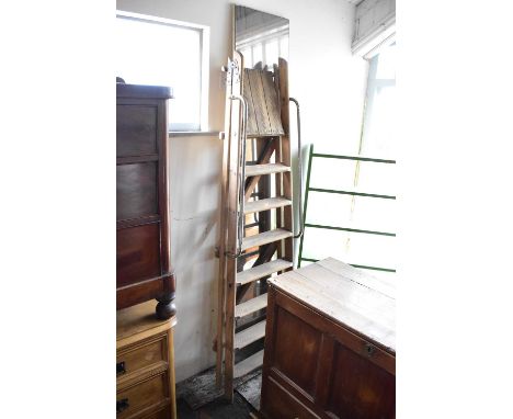 A vintage pair of wooden stepladders, together with a rectangular wall mirror (2).