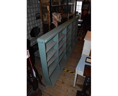 A large modern painted bookcase with an arrangement of shelves, height 138cm, width 295cm, depth 40cm.Condition Report: Depth