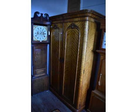 A 19th century satinwood twin door wardrobe, the moulded cornice above panelled arch shaped doors, on plinth base, width appr