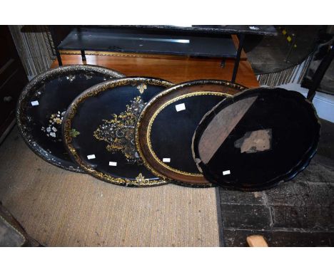 A collection of eight Victorian papier mâché trays including examples with mother of pearl inlay.