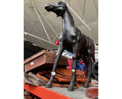 A leather horse figure and four vintage leather bags. 