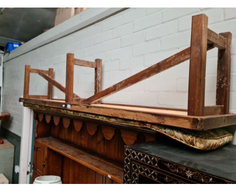 A long rustic bench with cushion. 