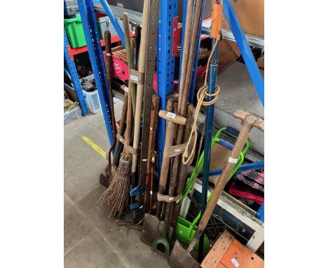 A collection of garden tools and drain rods and brushes 