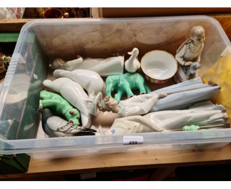 A box containing Nao figures and animals. 